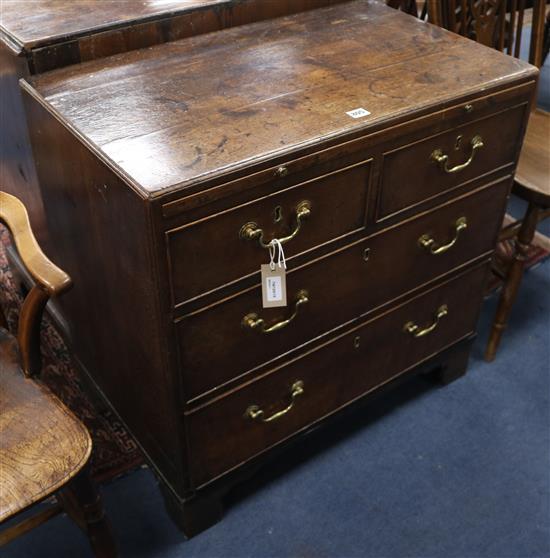 A Georgian oak caddy-top four-drawer chest, fitted brushing slide, on bracket feet, W.76cm